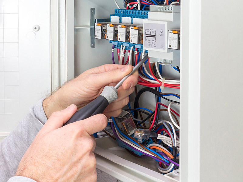 electrician hands close up with screwdriver wiring a breakers panel apache junction az