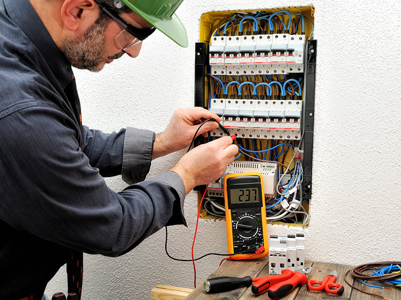 electrician wiring a new breakers panel at residential property apache junction az